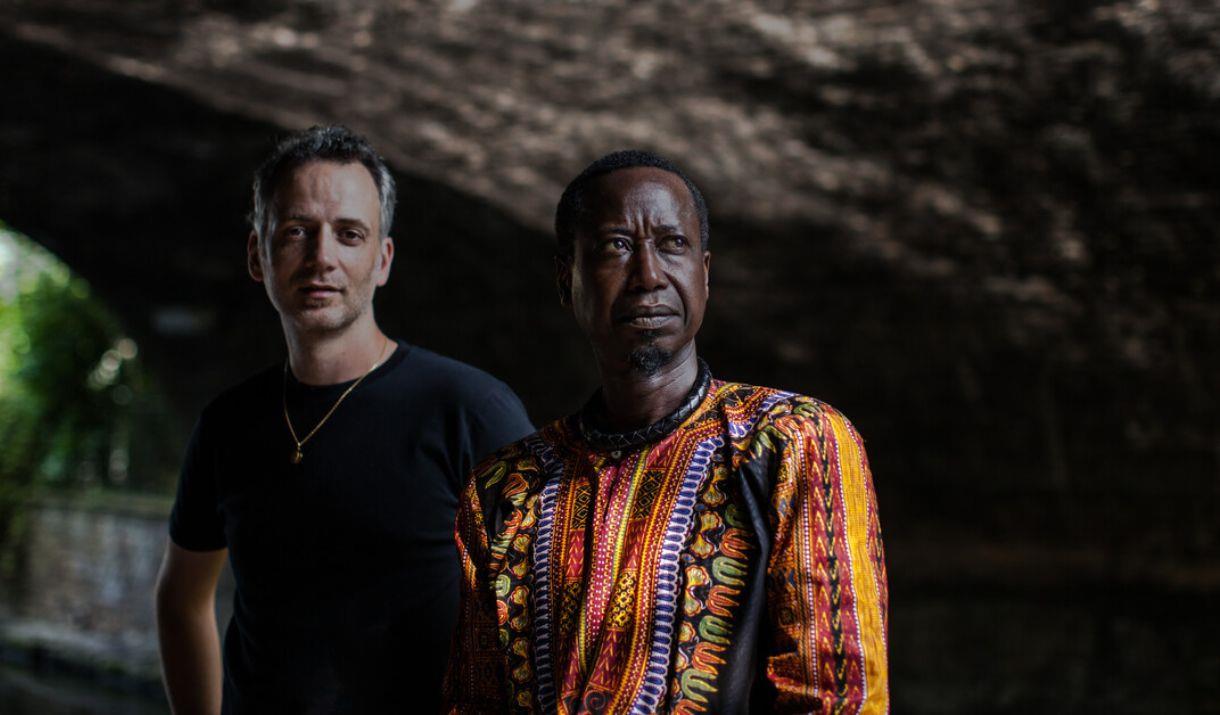 Two members of the Awale Jant Band standing outdoors