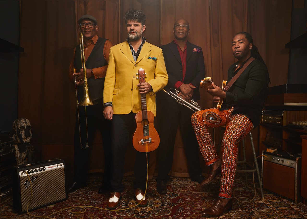 The band Kobo Town posing with their instruments.