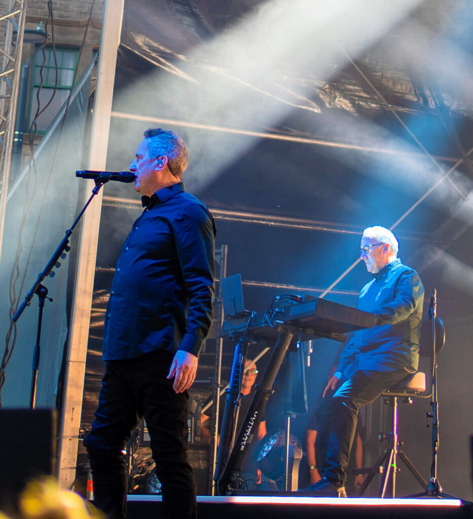 OMD performing live at Rochdale Town Hall Square in 2026